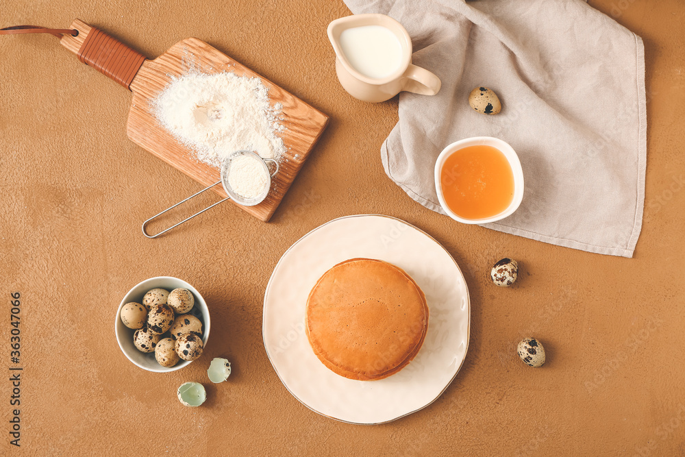 Tasty pancakes with ingredients on color background