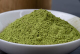 Fototapeta Mapy - matcha tea brewed in a brown bowl and matcha powder on the side