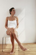 © ImageHit - Woman relaxing on chair, enjoying the sunlight