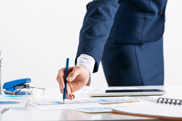 Wall Mural - Businesswoman standing near office desk with pen