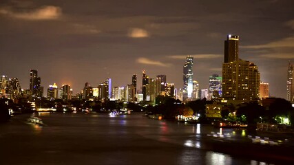 Wall Mural - Time lapse Bangkok City modern office buildings, condominium, hotel with Chao Phraya River at night time in the capital of Thailand