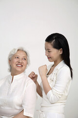 Wall Mural - Woman massaging senior woman's back