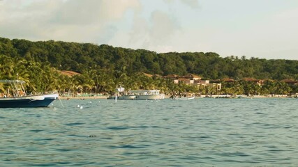 Wall Mural - A view of a small fishing boat moored near the shores of West Bay in the caribbean Island of Roatán.