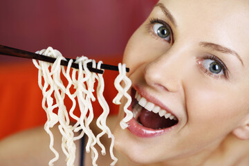 Wall Mural - Woman eating instant noodle