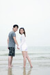 © ImageHit - Man and woman holding hands and walking on the beach