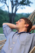 © ImageHit - Man sleeping on hammock
