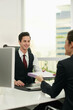 © ImageHit - Businesswoman passing document to businessman