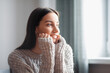 © VERSUSstudio - Beautiful young woman portrait behind window