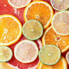 Beautiful Fresh Sliced Mixed Citrus Fruits Like Background. Concept Of Healthy Eating, Detox, Diet. Top View.