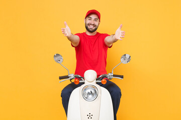 Wall Mural - Delivery man in red cap t-shirt uniform driving moped motorbike scooter isolated on yellow background studio Guy employee working courier Service quarantine pandemic coronavirus virus covid-19 concept