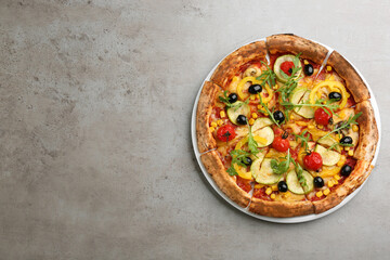 Delicious vegetable pizza on grey table, top view. Space for text