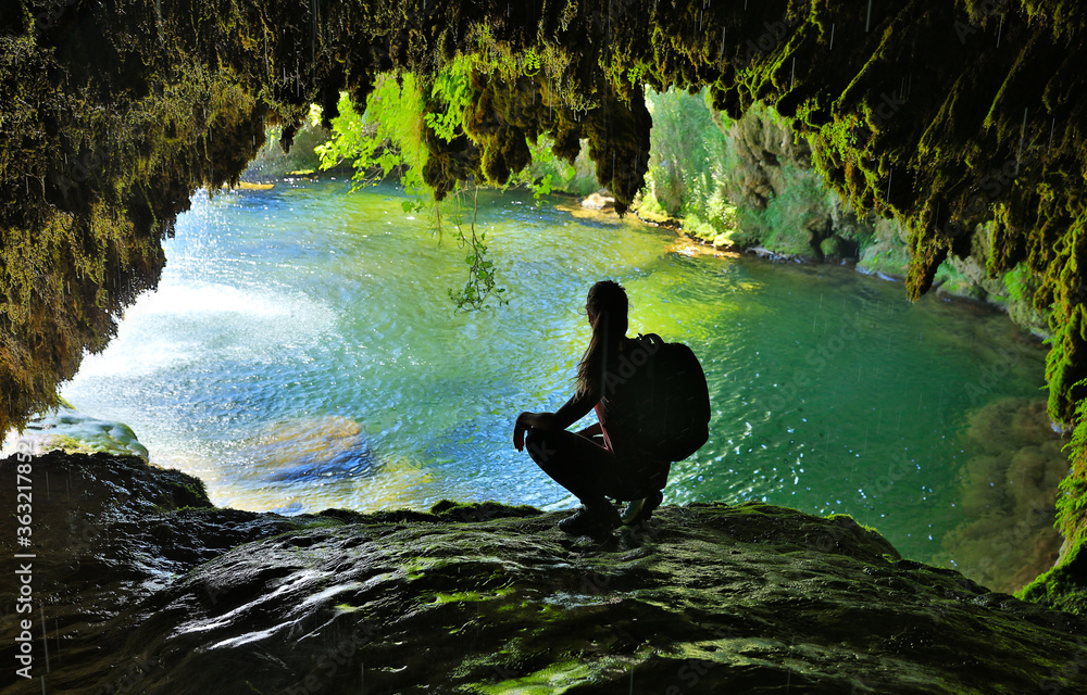 beautiful cave with blue lake and woman tourist - obrazy, fototapety, plakaty 