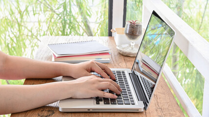 Wall Mural - Woman working at home office hand on keyboard.