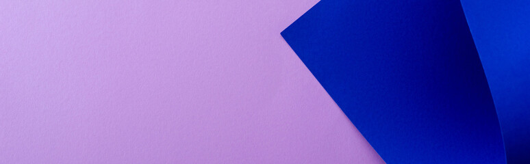 Sticker - curved blue paper on violet background, panoramic shot