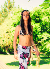 girl with long hair in a swimsuit walking on the tropics