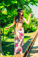 Wall Mural - girl with long hair in a swimsuit walking on the tropics