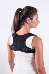 Instruction how to wear posture corrector. Different angels. Women wearing back support belt for support and improve posture consists of two parts for the back and lower back. Details, quality