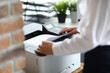 © H_Ko - Woman in office prints documents on printer. Scanning documents at workplace concept