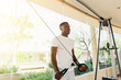 © twinsterphoto - Muscular African American sportsman doing cable fly with exercise machine standing against window during training in gym.