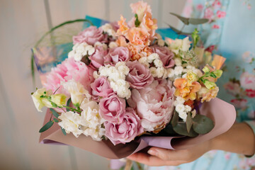Wall Mural - Wedding bouquet at the florist in the hands of roses peonies flowers