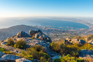 Wall Mural - Cityscape and landscape of Cape Town at sunset with the Indian Ocean seen from the Table Mountain National Park, South Africa.