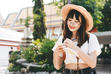 Wall Mural - Young asian cute glasses teenager girl traveller backpack solo local travel with memo written daily.