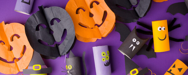 Collection of Monsters from toilet tube on purple for halloween decor. A terrible craft. School and kindergarten. Handcraft creative idea, seasonal autumn holiday pattern, banner, flyer