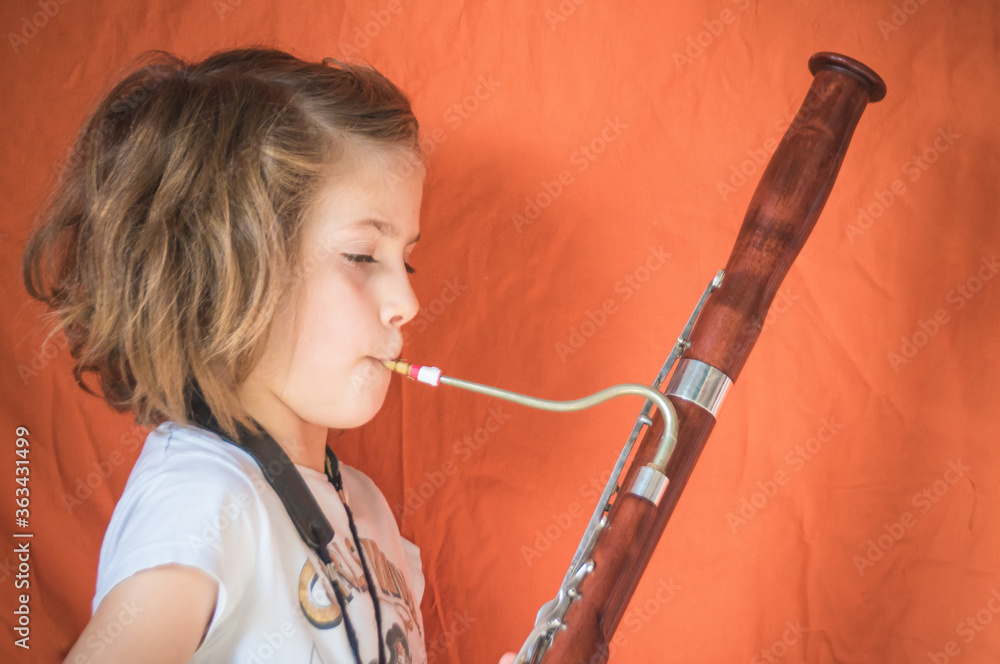 Side View Portrait Of A Girl Playing Bassoon - obrazy, fototapety, plakaty 