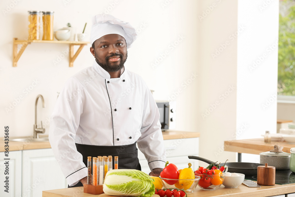 Male African-American chef cooking in kitchen