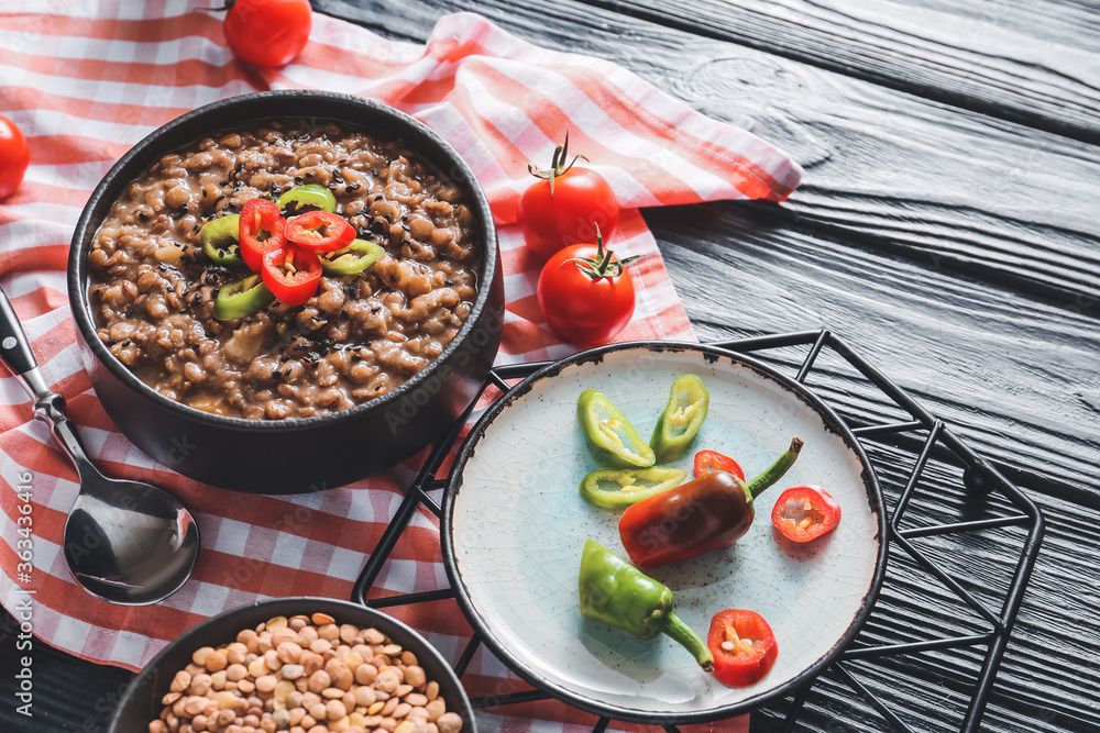 Bowl of tasty lentils soup on table