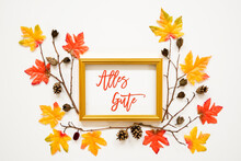 Golden Frame With German Text Alles Gute Means Best Wishes. Beautiful, Colorful Autumn Leaf Decoration With Maple Leaf And Fir Cone. White Background