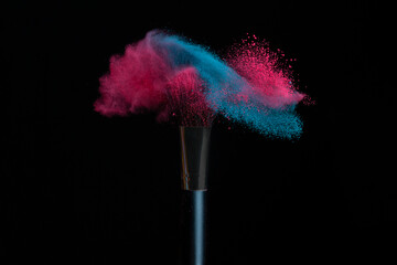 Blue and pink makeup on powder brush hit in a mixed cloud