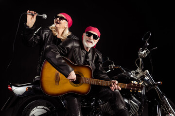 Canvas Print - Photo of aged bikers man lady duet couple sit chopper moto rock bike festival meeting play sing guitar songs remember youth wear rocker leather jacket pants isolated black color background