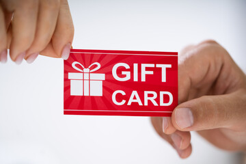 Wall Mural - Close-up Of Person Hand Giving Gift Card