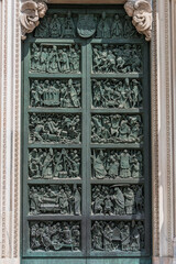 Heavy big metal doors to Duomo di Milano, Cathedral of Milano, Italy