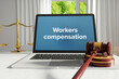 Workers compensation. Law. A lawyer laptop on a desk in the office. Text on the screen. Libra, Juctice, Web