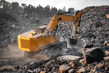 Yellow excavator works and extracts coal from bowels of earth. Open pit mine industry