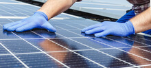 Male Worker Hands In Glows On Solar Panel, Technician Installing Solar Panels On Roof. Alternative Energy Sun Energy Power, Ecological Concept. Long Web Banner