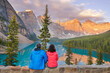 © romylee - a couple watching the sunrise over Moraine Lake