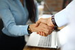 Man and a woman in office shake hands. Successful agreement business partners concept