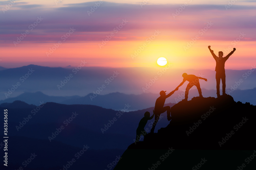 Teamwork friendship hiking help each other trust assistance silhouette in mountains, sunrise. Teamwork of two men hiker helping each other on top of mountain climbing team beautiful sunrise landscape - obrazy, fototapety, plakaty 