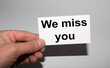© Stanislau - Message on the card WE MISS YOU, in hands of businessman.