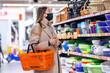 © Ivan - masked woman holding basket in supermarket