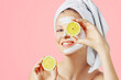 © Olesia - Cosmetology, skin care, face treatment, spa and natural beauty concept. Woman with facial mask holds lemons.