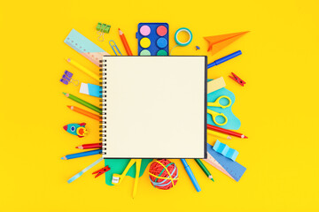 Wall Mural - School notebook with school supplies on grid background. Back to school. Elementary school concept.	
