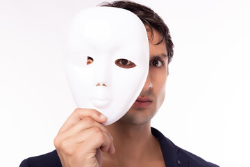 businessman hold white mask in his hand. man is dishonest cheating person. faking, cheating business