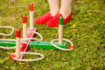 Close up view of ring pole tossing game outdoors in home garden, summer day. Family garden play time concept.