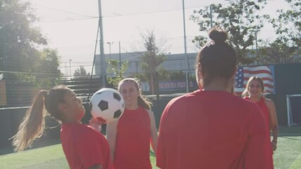 Wall Mural - Player kicking ball as female soccer team warm up during training before match - shot in slow motion