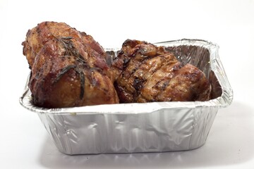 Canvas Print - Closeup shot of Chicken carcass roll on a white background