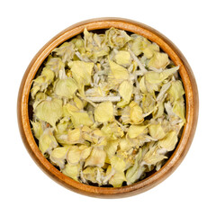 Wall Mural - Greek mountain tea in wooden bowl. Also known as ironwort, Sideritis or shepherds tea. Dried flowering plants used as herbal medicine and tea.Closeup from above, over white, isolated macro food photo.